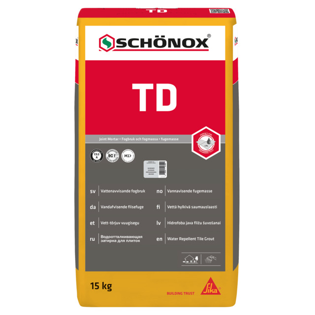 Förpackning med Schönox TD fogbruk, 15 kg, röd och gul design med text på flera språk.
