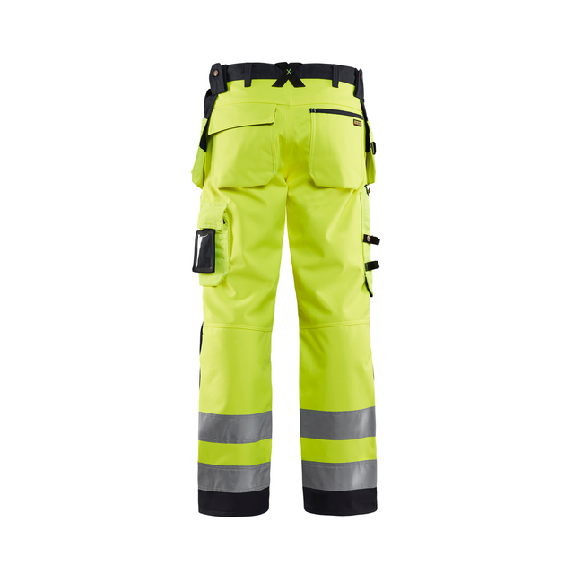 Arbetsbyxor i neongult med svarta detaljer, reflekterande band på benen och flera fickor.