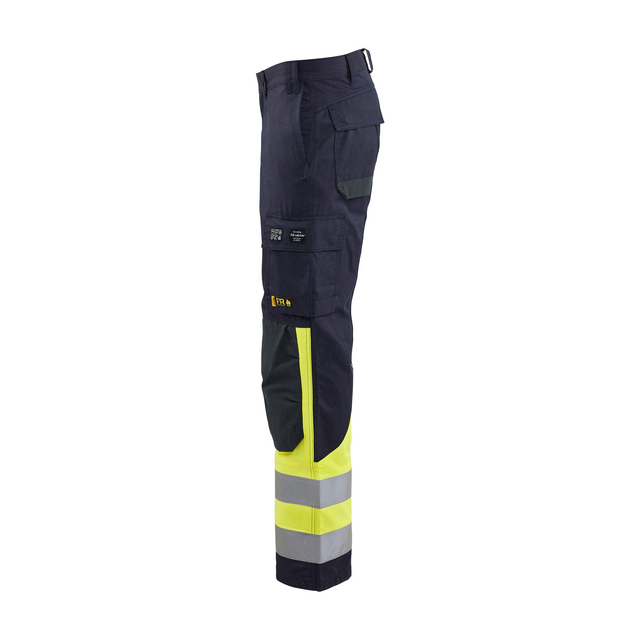 Byxben av arbetsbyxa i mörkblå och gul med reflexband, fickor och hällor.