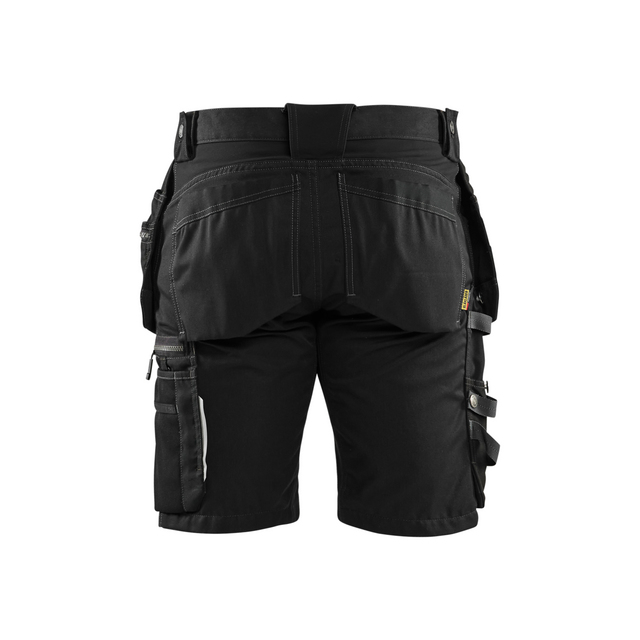 Svarta arbetsshorts med flera fickor och hällor, sett bakifrån.