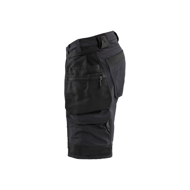 Svarta arbetsbyxor i sidovy med flera fickor och förstärkta sömmar.