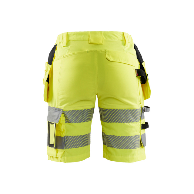 Gula arbetsshorts med reflexband och flera fickor, sedda bakifrån.