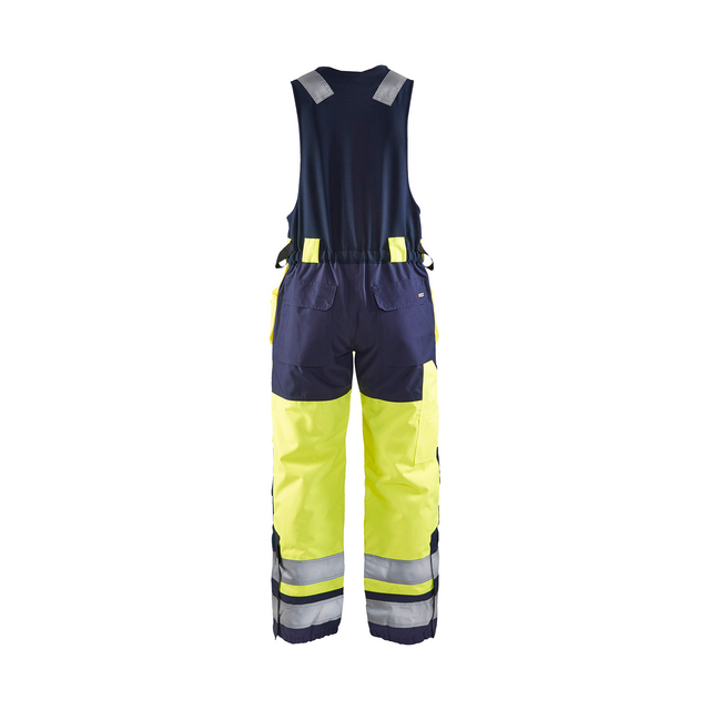 Mörkblå och neongul högsynlighet hängslebyxa med reflexband och fickor, sett bakifrån.